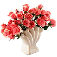 2 dozen peach roses in a vase